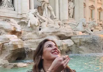 Participant throws a coin into the Trevi Fountain