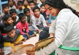 Volunteer reading to children.