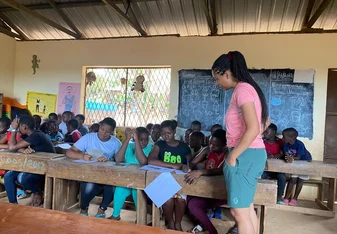 A dedicated volunteer sharing knowledge and inspiring young minds at Arloste Ganze Foundation.