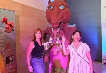 Ana visiting sites and standing in front of a dinosaur while on her program with Spanish Express