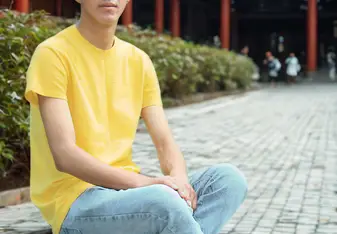 Amin Rahman sits on steps in front of traditional Chinese building