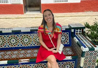 Lily smiles while sitting on decorative stairs