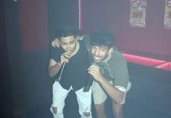 Mickey and a friend having fun and singing into a microphone