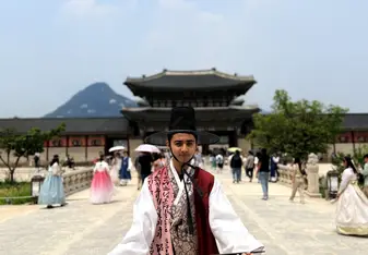 Mickey poses in traditional South Korean clothing