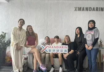 Clara and friends pose with XMandarin sign