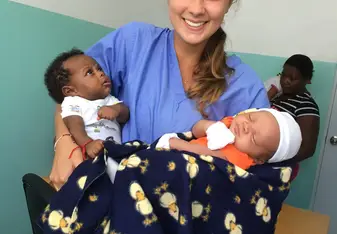 Me at the hospital with two newborn babies