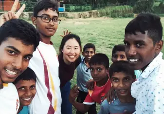 After playing volleyball with local boys, they want me to take a selfie with them.
