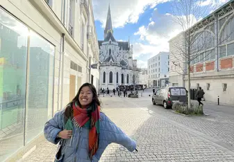 A student smiling in the streets of Nice.