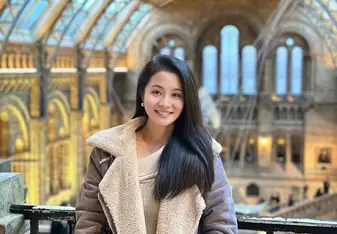 Kitty poses for a photo in a train station