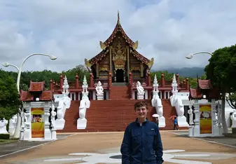 Eugene smiles for a photo in front of a Temple