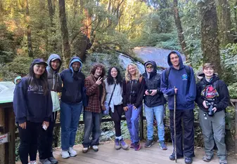 Eugene and fellow students pose for a photo in the forest