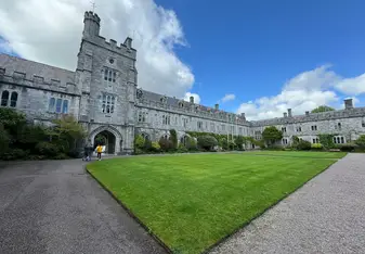 Large university building with grass in front