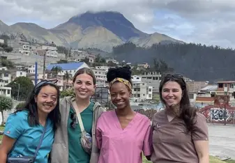 A group of medics/nurses posing in front of a mountain in Ecuador