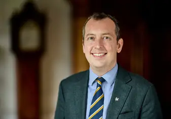 Dr. Christopher Adams smiles for a proffesional headshot
