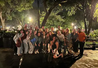 Hayley and a large group of friends gathered together for a photo at night