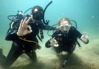 Volunteers scuba diving together during a marine conservation program in southern Tanzania