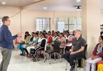 A room of students attending a course, watching the trainer. 