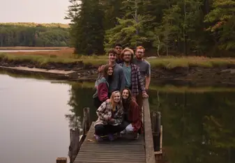 Clara and friends pose for a photo on a lake dock