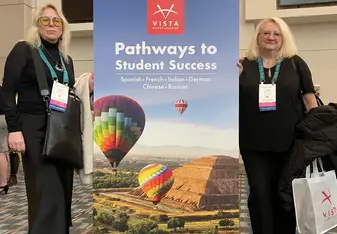 image of two women standing in front of an educational poster