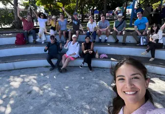 woman and group of people smiling in a semicircle seating area