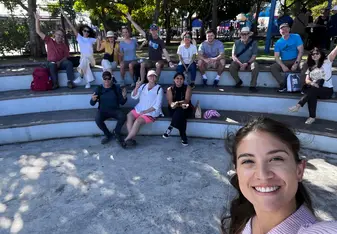 woman and group of people smiling in a semicircle seating area