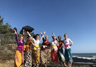 Students in traditional clothes on beach in Indonesia
