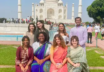 Students pose in front of the Taj Mahal.