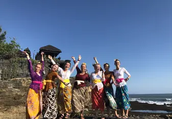 Students in traditional clothes on beach in Indonesia