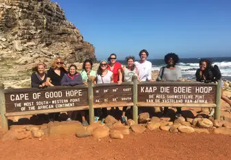 Students pose at Cape of Good Hope sign.