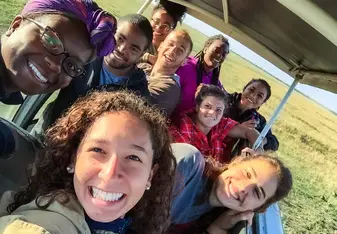 Group photo in safari vehicle.