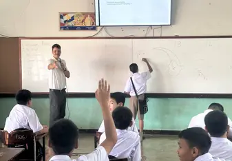 Teacher teaching Infront of the class
