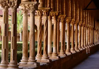 Row of decorated medieval columns in the Monreale Cathedral cloister, Sicily