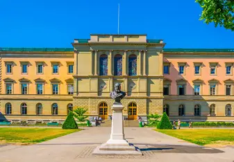 historic building with a large statue in front