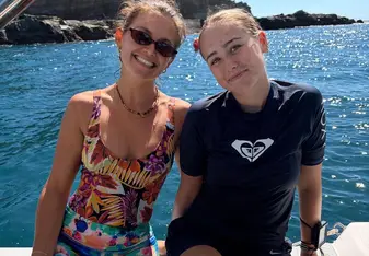 two girls sitting on a boat