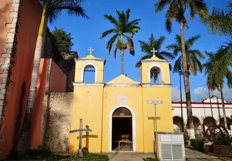 The sun setting on Carrillo Puerto's church in the central square