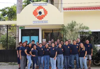 Na'atik staff outside the school
