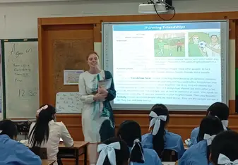 Teacher teaching Infront of the class