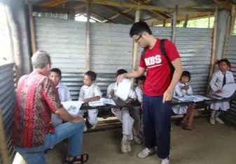 A group of volunteers assisting during homework class at the school