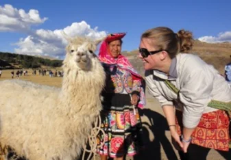 student blair meets a llama in peru