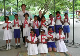 A volunteer with local kids from South East Asia