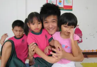 Volunteer helping disabled children