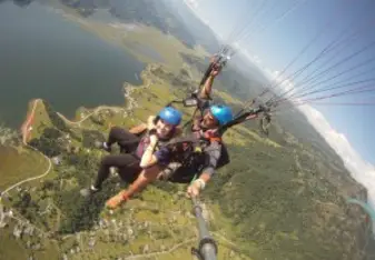 Paragliding at Pokhara with beautiful lake and mountains.