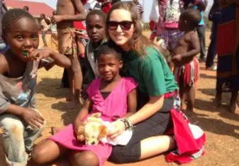 Masha at the orphanage in Swaziland holding a 8 year old girl.