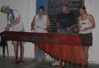 Avery jamming out on a hand carved Marimba with friends