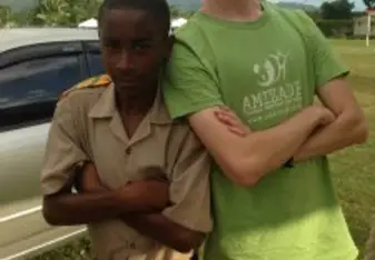 Joshua with a local student in Jamaica during his Amizade volunteer trip. 