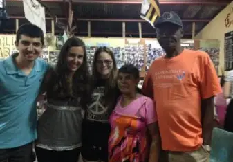 Joshua with his host family in Jamaica.