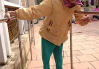 A young girl improving her walking as others cheer
