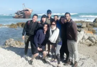 students smiling on the beach