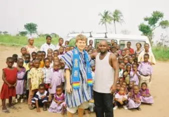 Godwin and Jack standing in front of the school