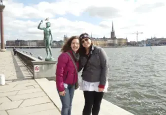 two women posing by the water in stockholm sweden